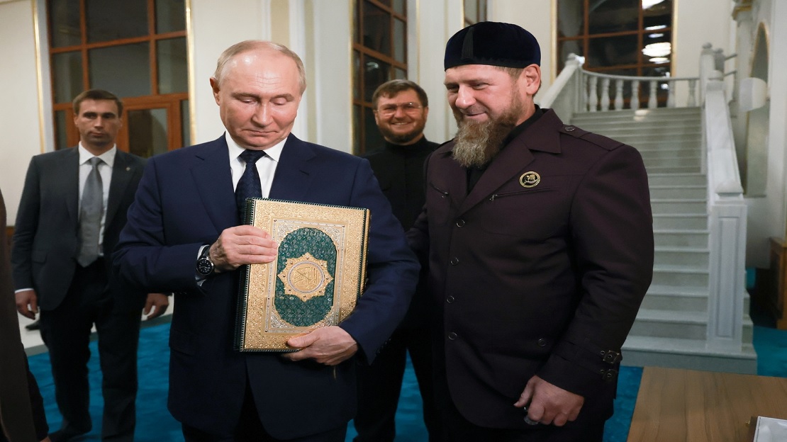 Putin kisses a copy of the Holy Quran during his visit to Chechnya